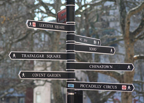Photo showing signpost directing in different directions to famous locations in Central London
